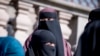 DENMARK -- Women wearing the niqab exit the Danish Parliament at Christiansborg Castle in Copenhagen, May 31, 2018